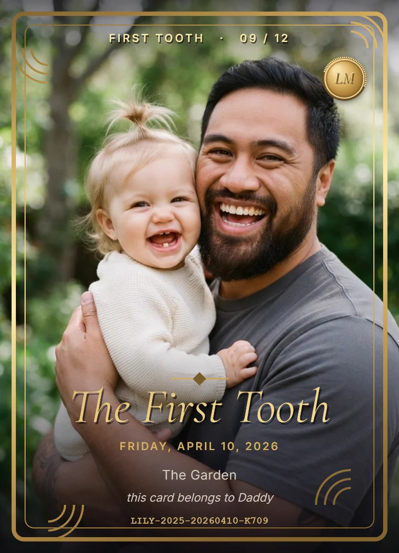 A nine-month-old baby girl showing her first tooth in her laughing father&rsquo;s arms in a garden, on a full-bleed green and gold keepsake card